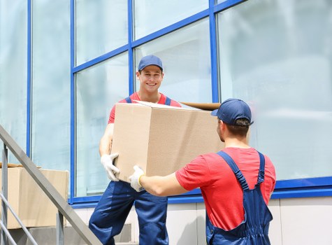 Packed moving boxes and household items ready for transport in Harlesden