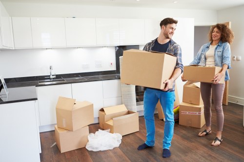 Family moving items into secure storage in Harlesden